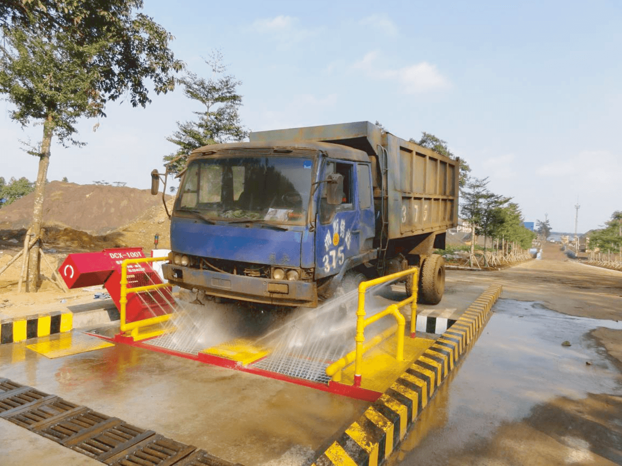 Drive through wheel wash